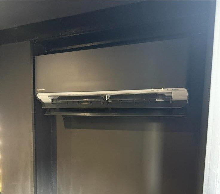 AC unit installed inside a fitted wardrobe alcove